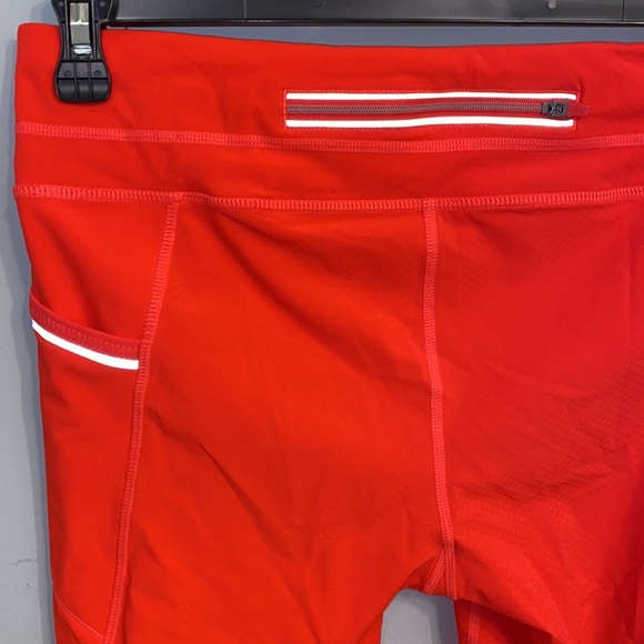 Athleta NWOT orange, thin leggings with side pockets, zip packet size Medium - Picture 6 of 7